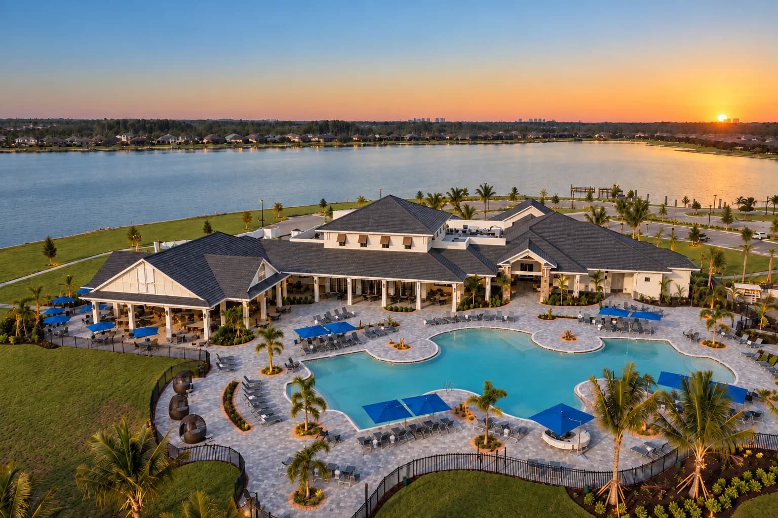 WildBlue clubhouse and pools overlooking the lake at sunset