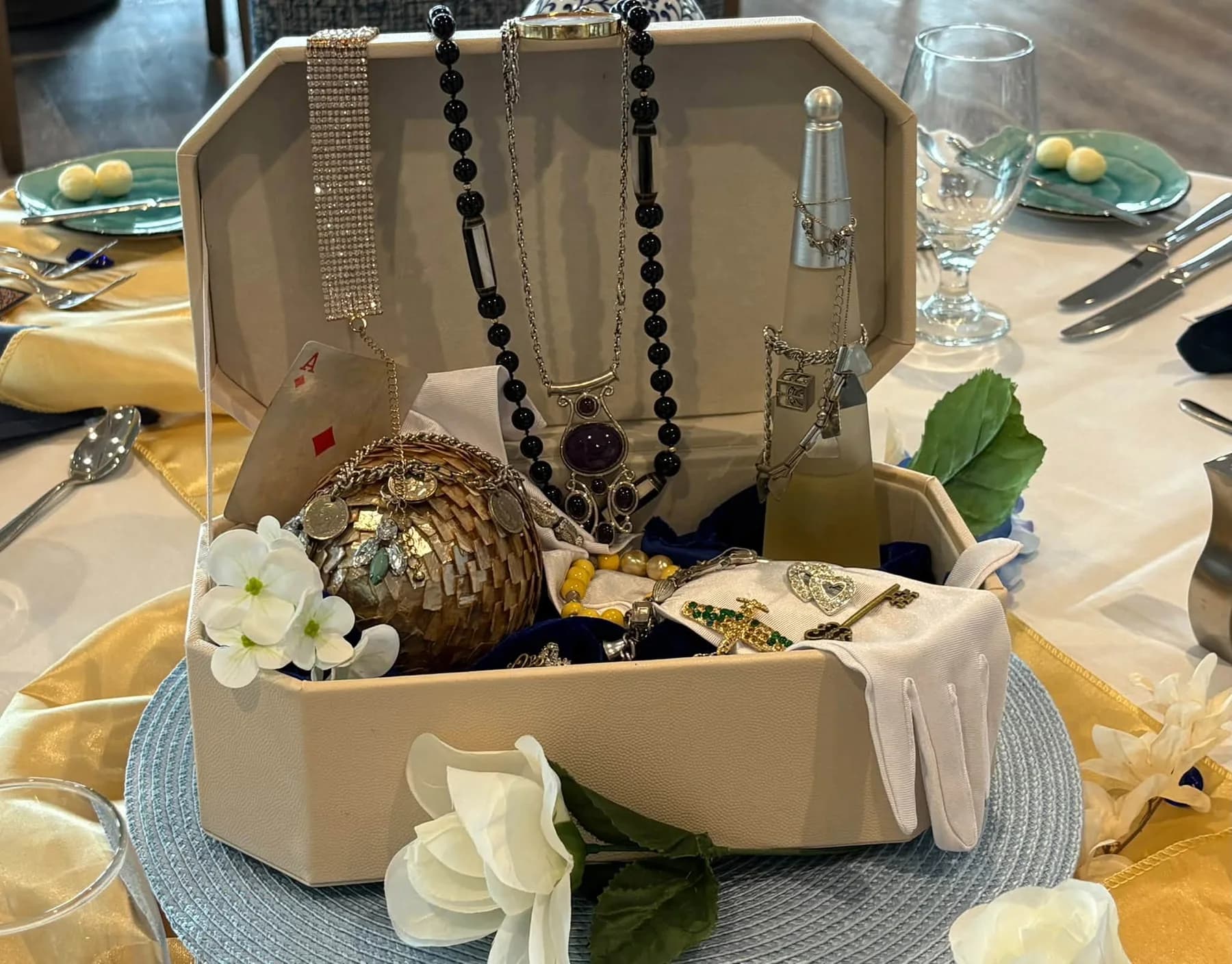 Pearls and jeweled accessories displayed in an open centerpiece box