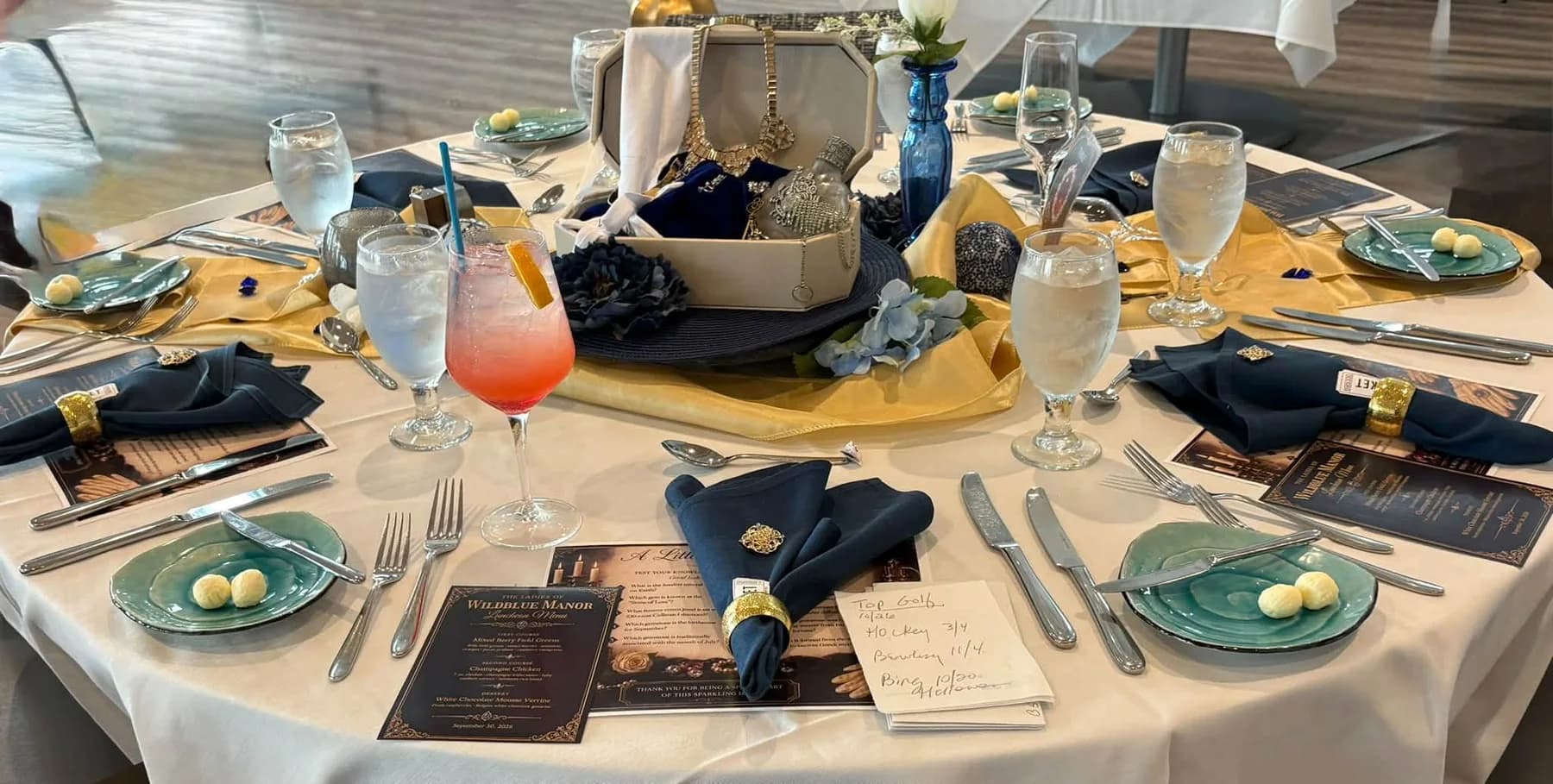 A table ready for lunch with menus, jewelry, and welcome drinks