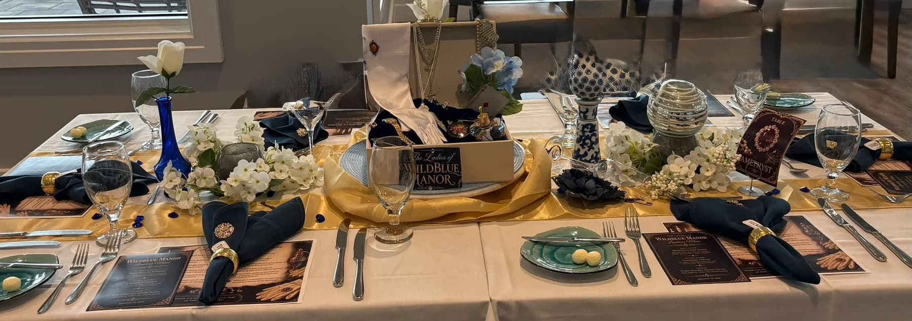 A wide view of the decorated luncheon table and place settings