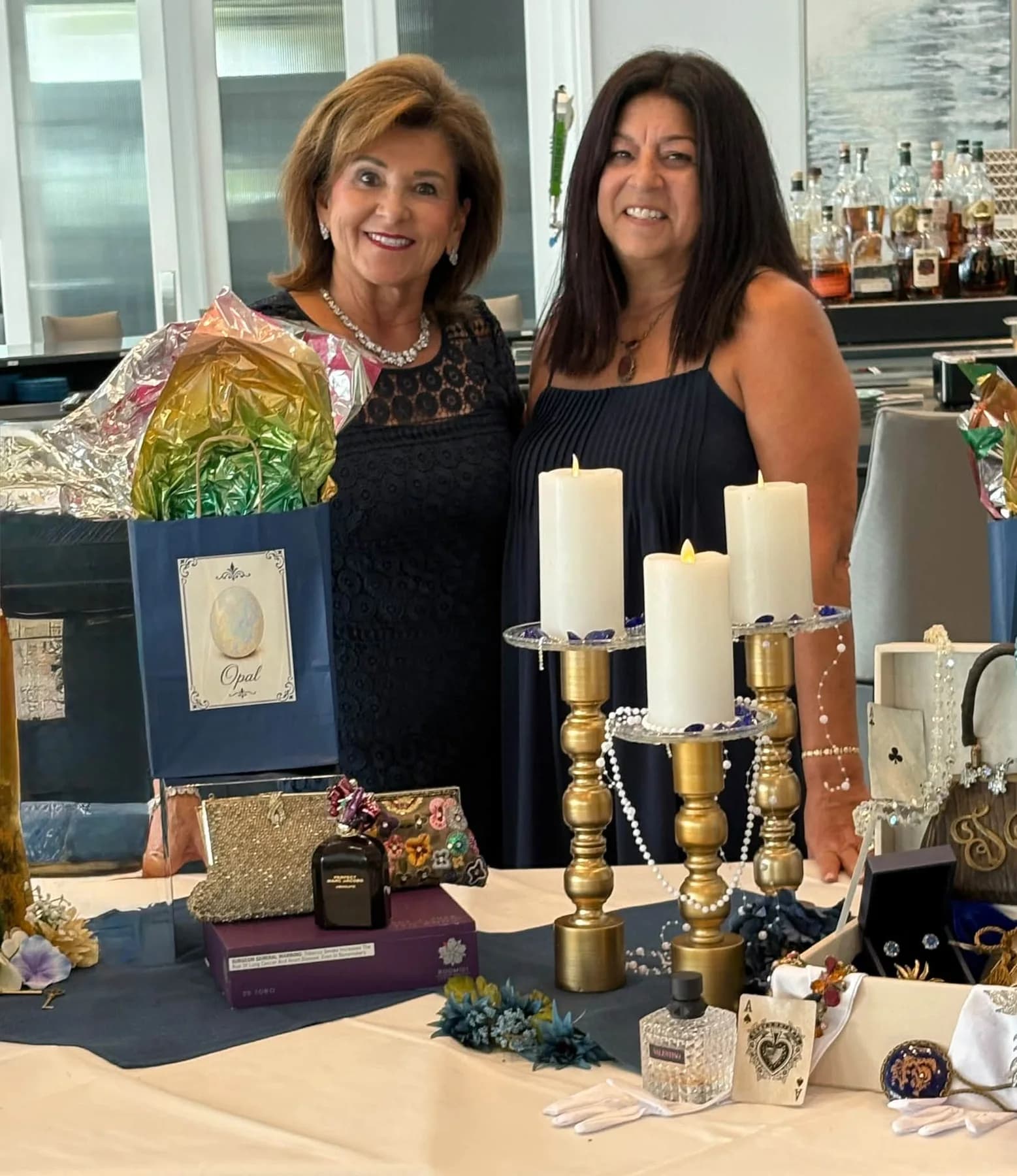 Two smiling guests beside the luncheon gift display